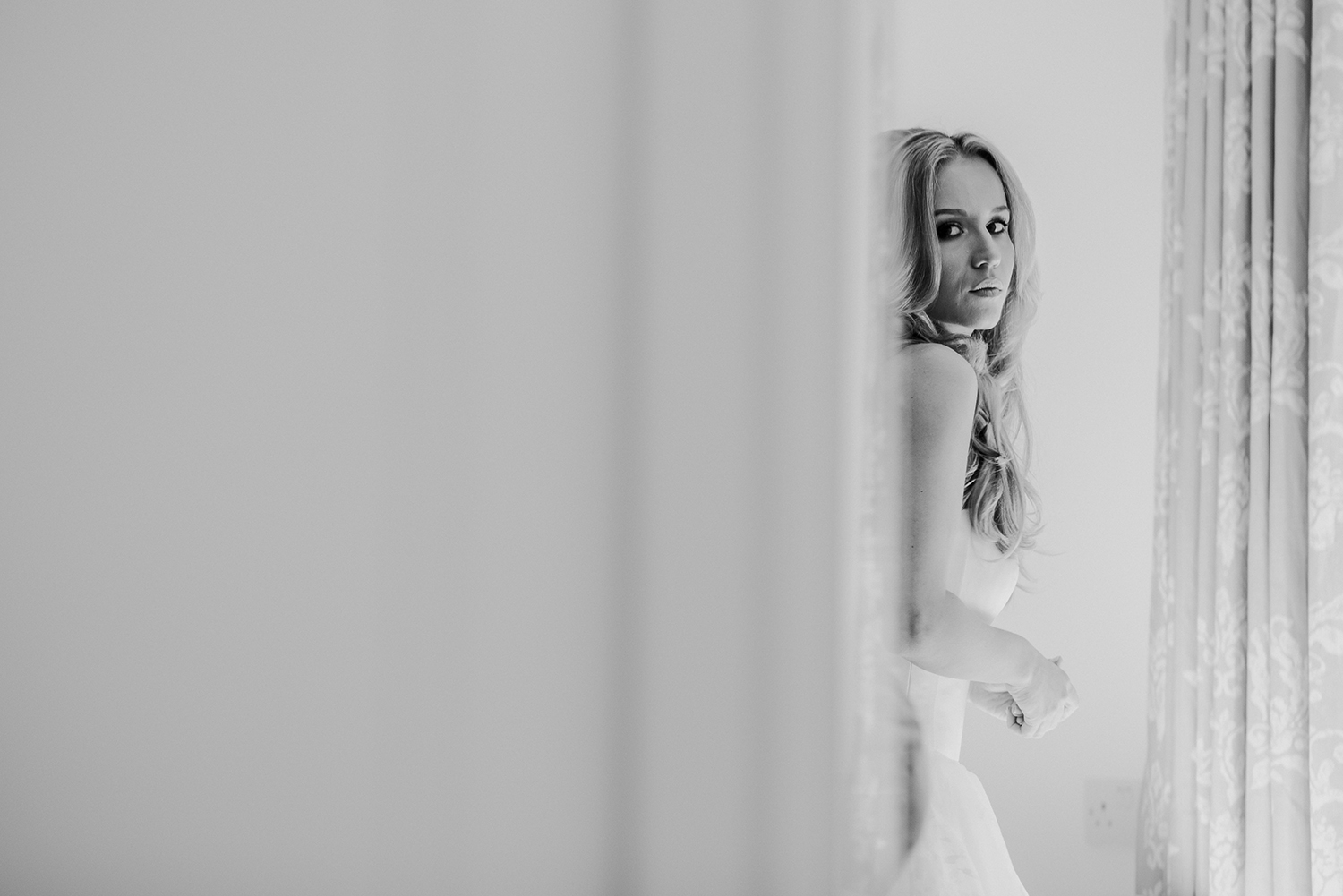  bw photo of bride looking in the mirror 