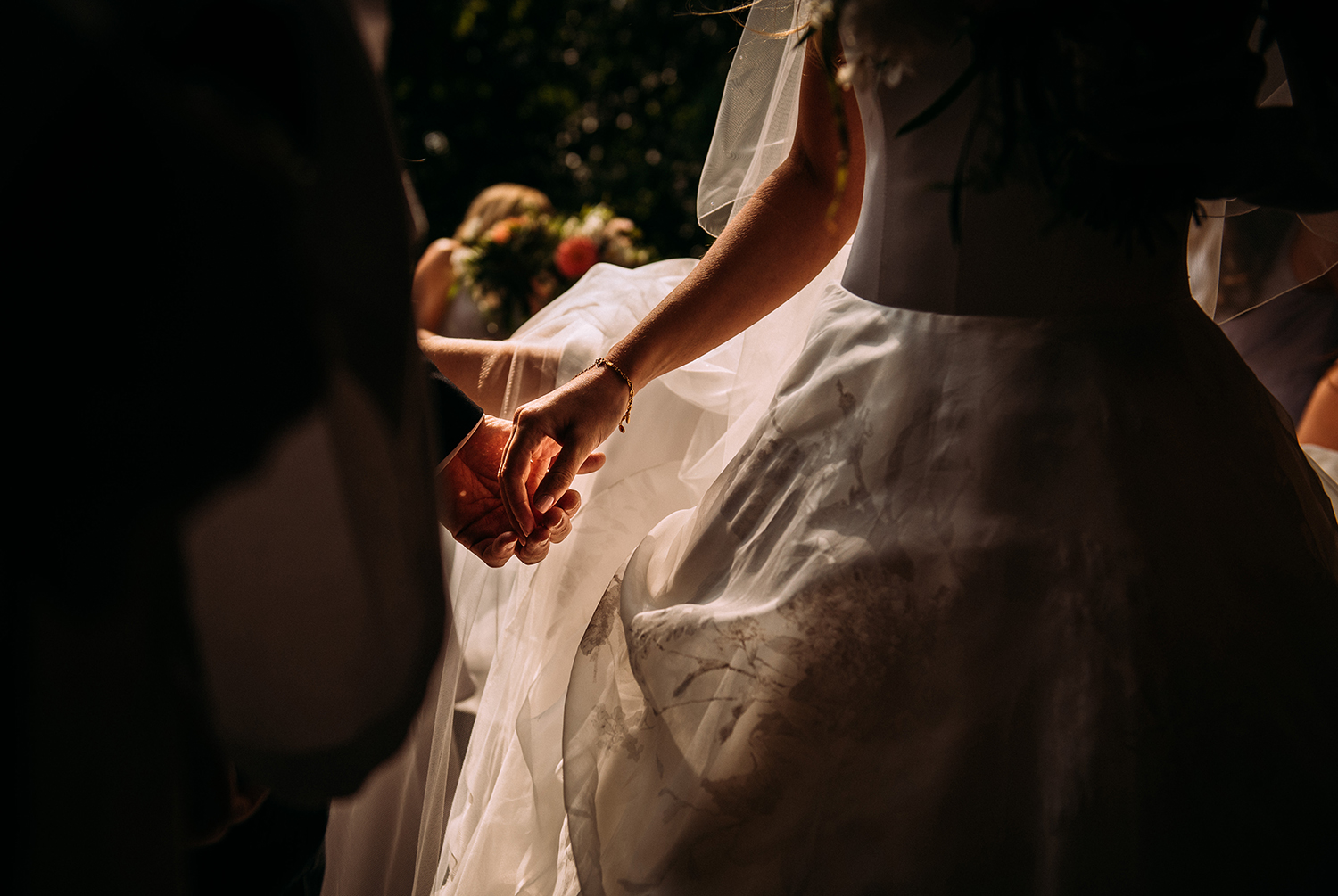  nicely lit shot of brides father letting go of her hand 