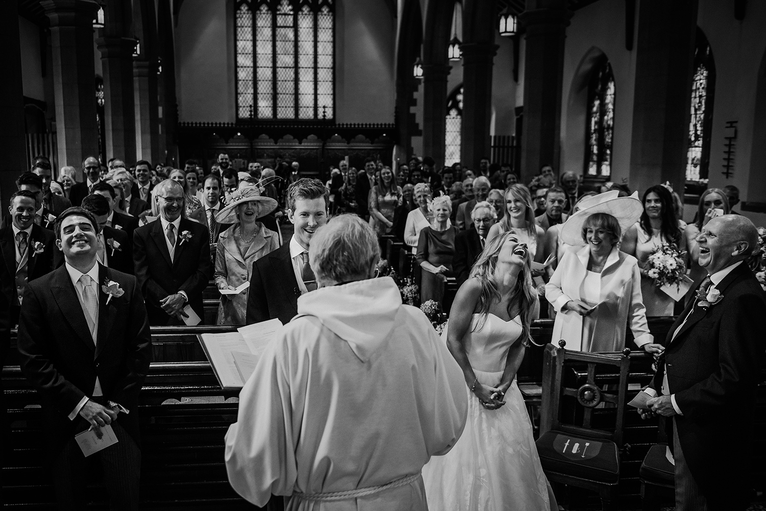  BW photo of every one in church laughing 