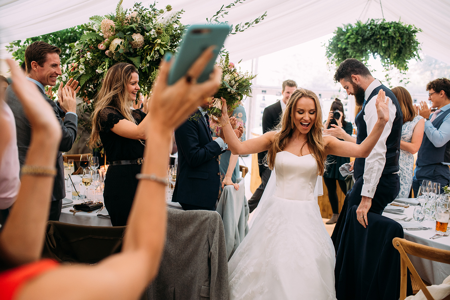  bride enters the reception with her hands in the air 