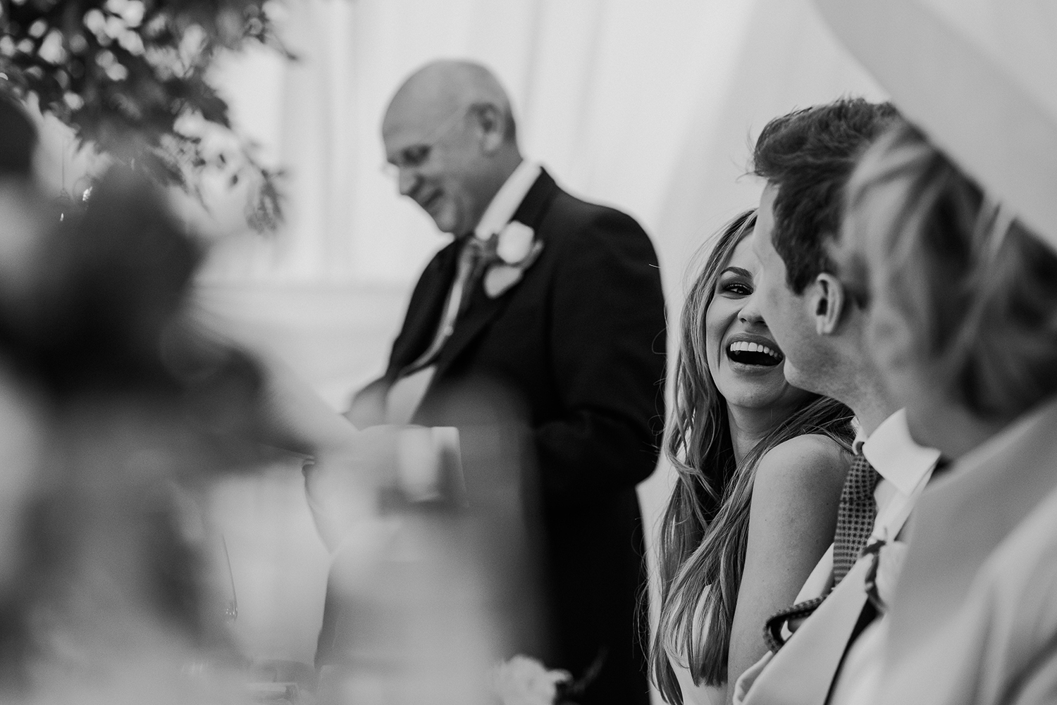 BW photo of bride laughing at the groom
