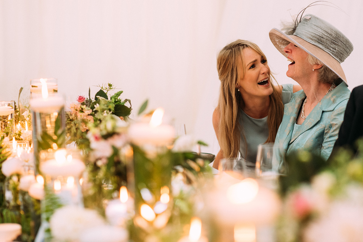  grooms mother and sister laughing together 