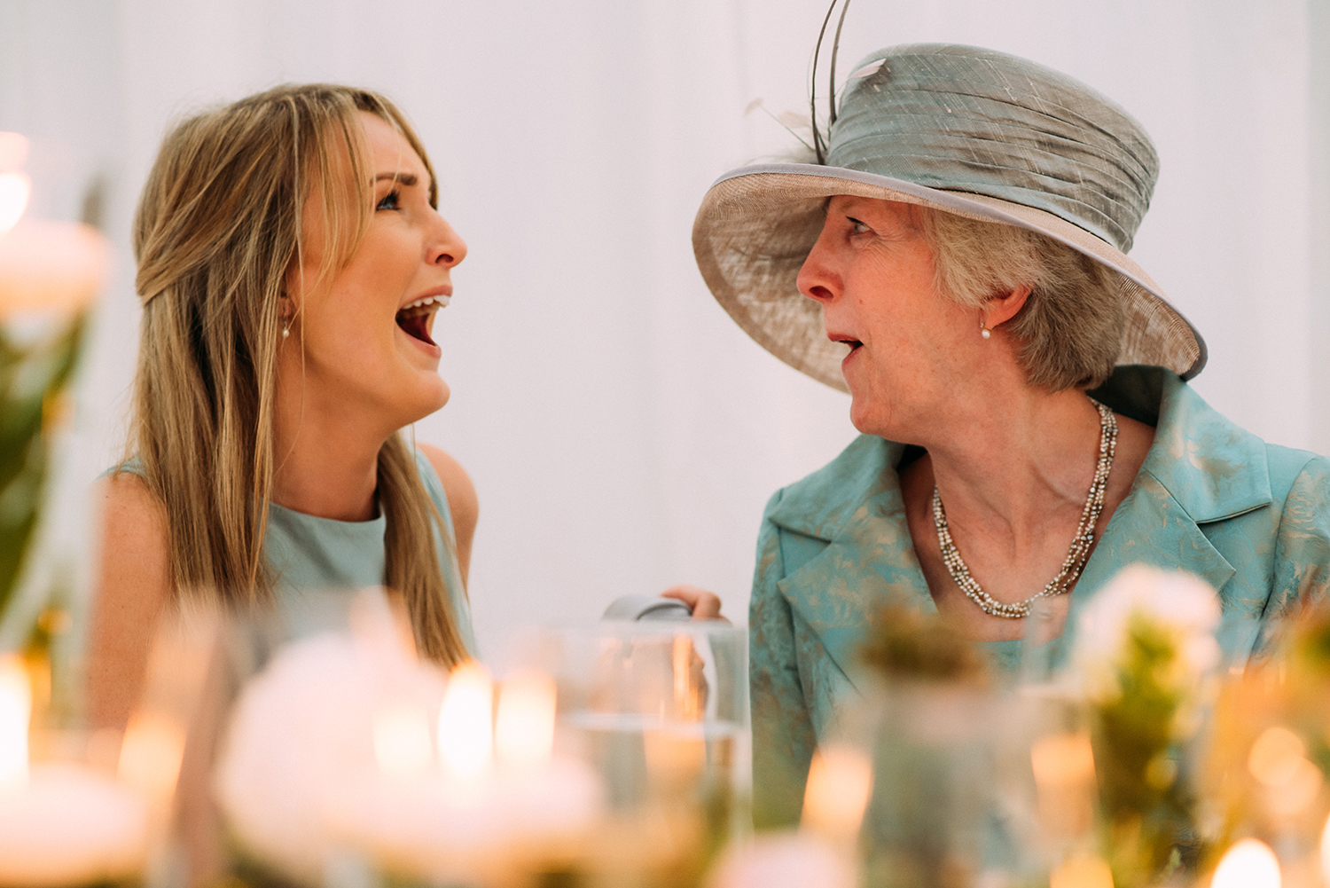  closer shot of grooms sister and mother really laughing 