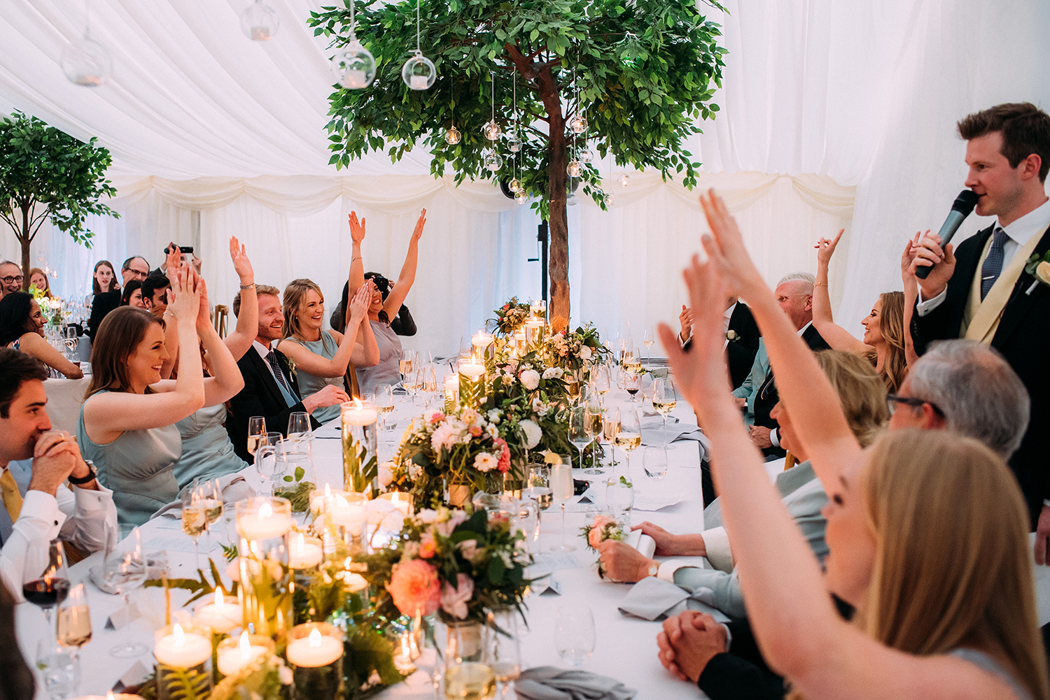 everyone cheering and clapping during the grooms speech