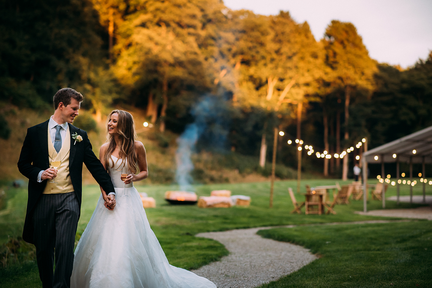 bride and groom walk towards the river