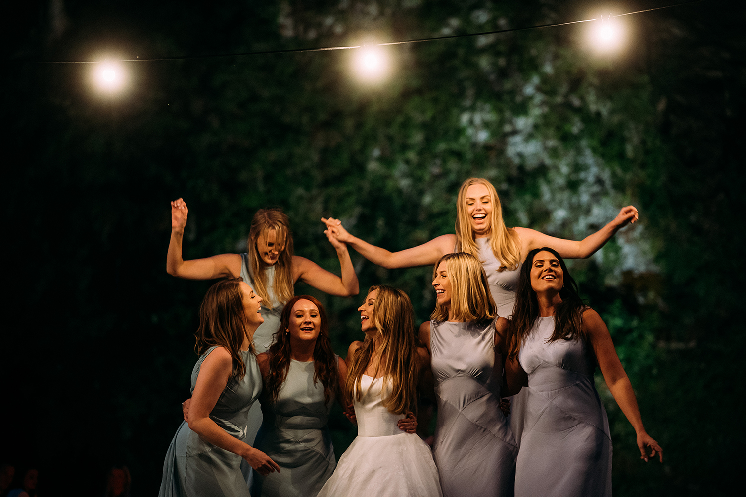  bridesmaids party under festoon lights 