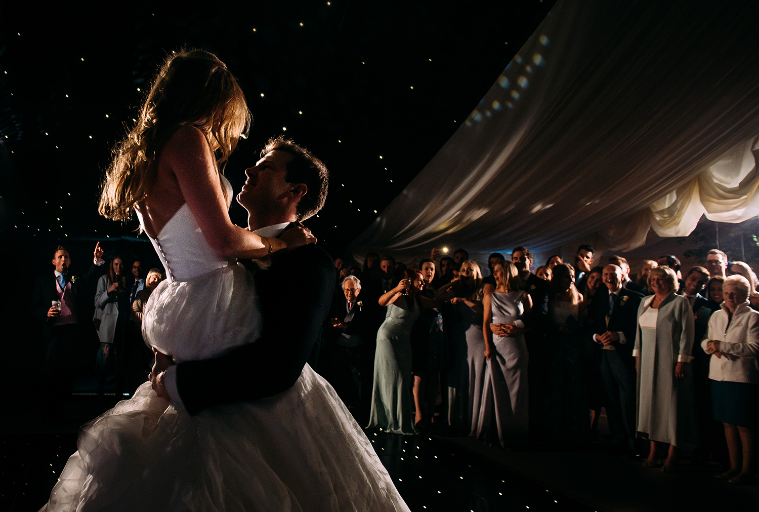  groom lifts and spins his wife during the first dance 