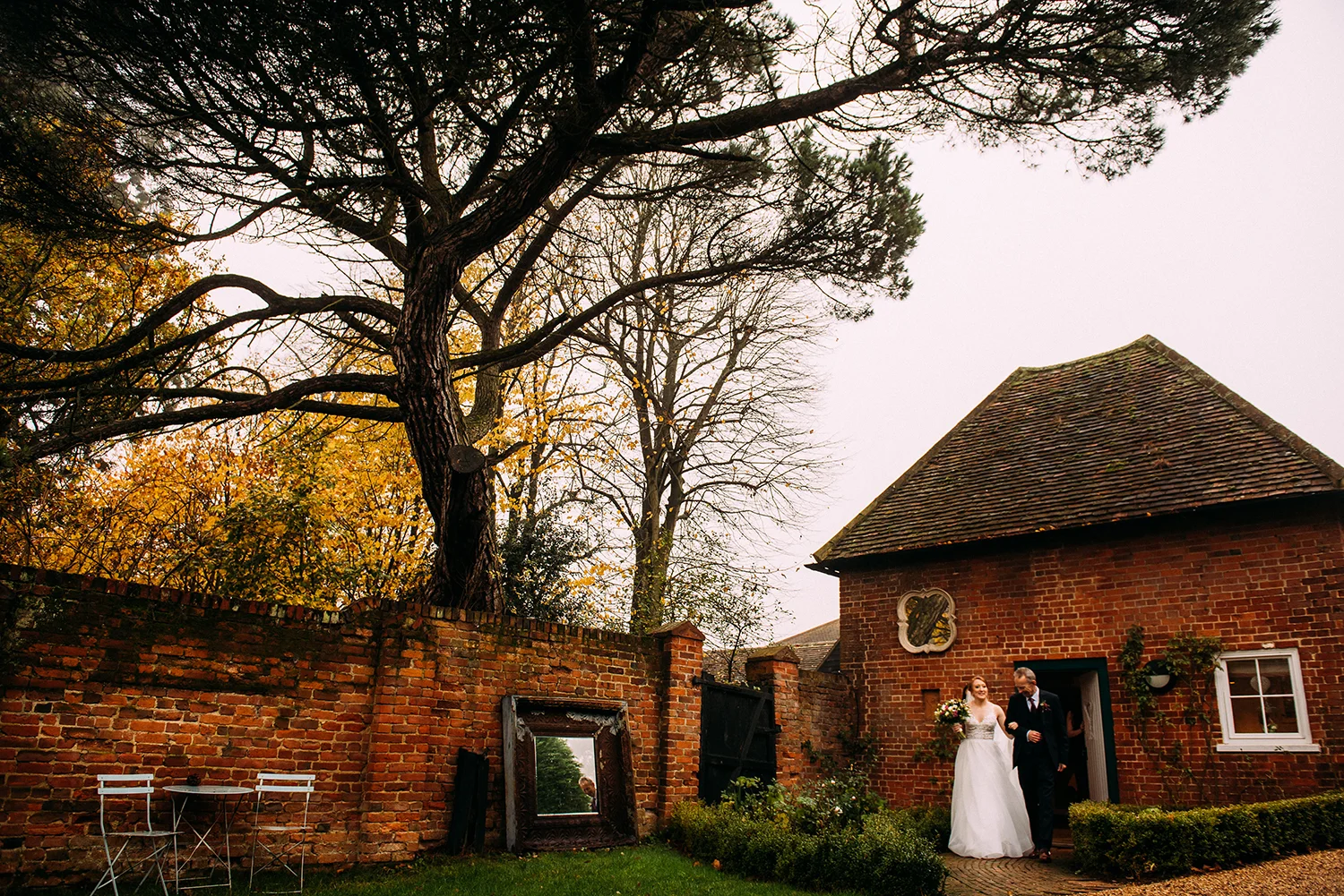 bride and father coming out of the apple loft cottage