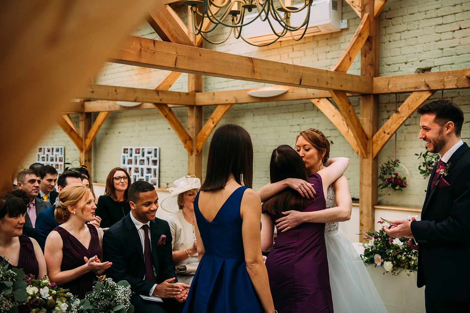 the bride kissing the friends after the reading