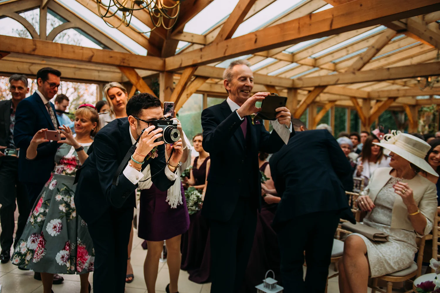 guests taking photo’s of the couple as they sign the register