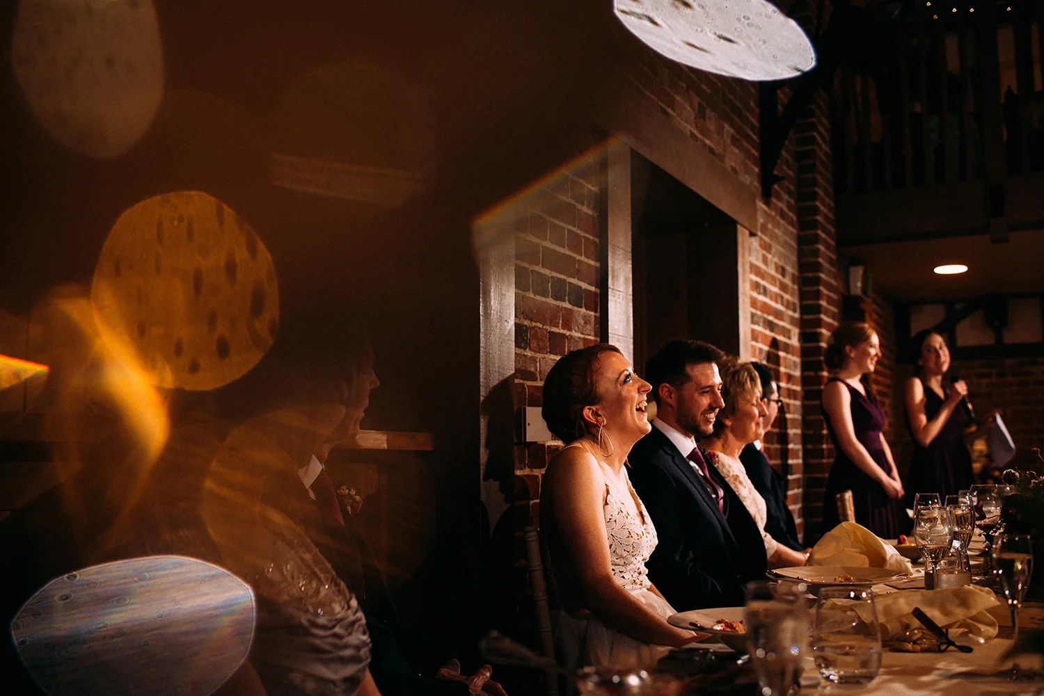 bride laughing at the bridesmaids speech