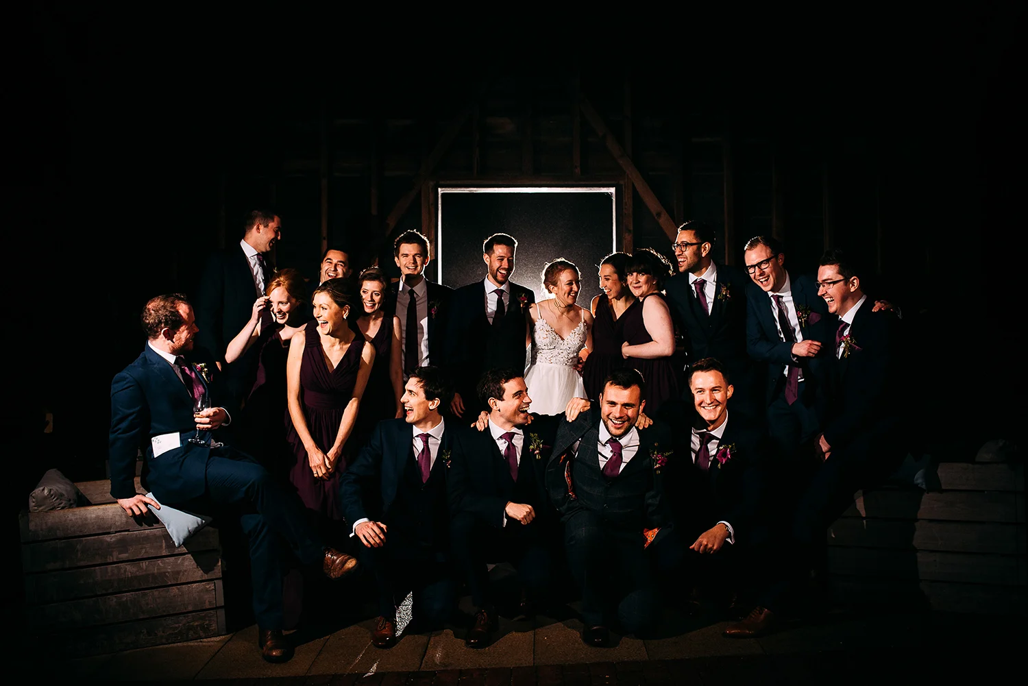 big group photo of the bridal party in the barn