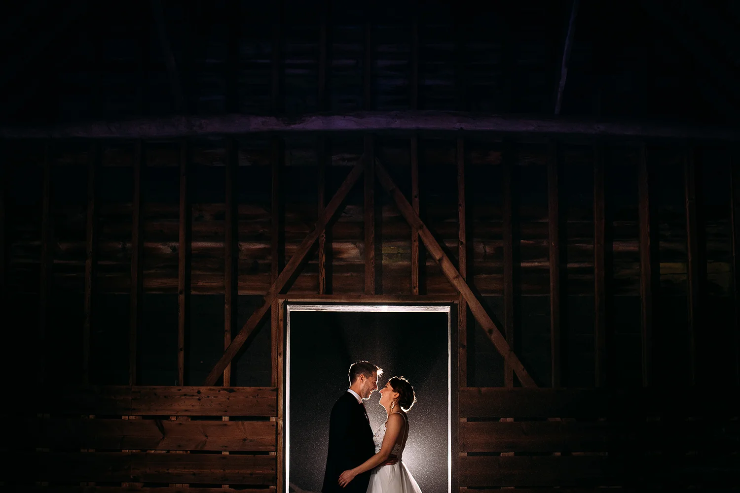 night time couple portrait in the barn