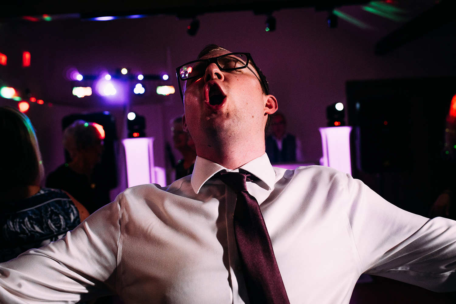  close up of a man shouting on the dance floor 