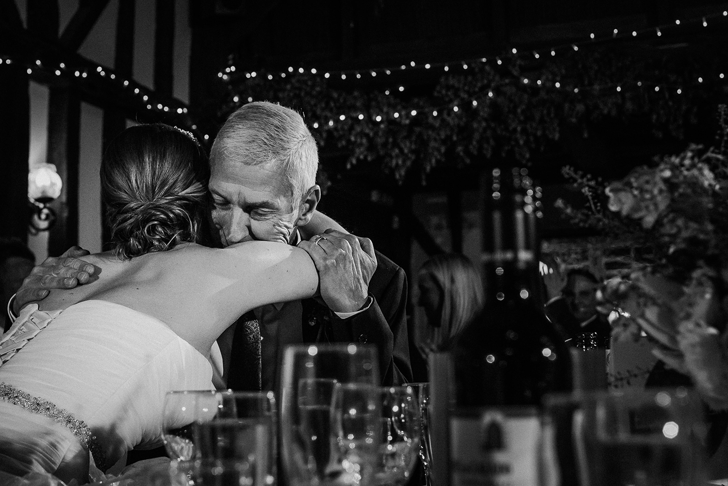 bw photo of the bride hugging her dad after his speech