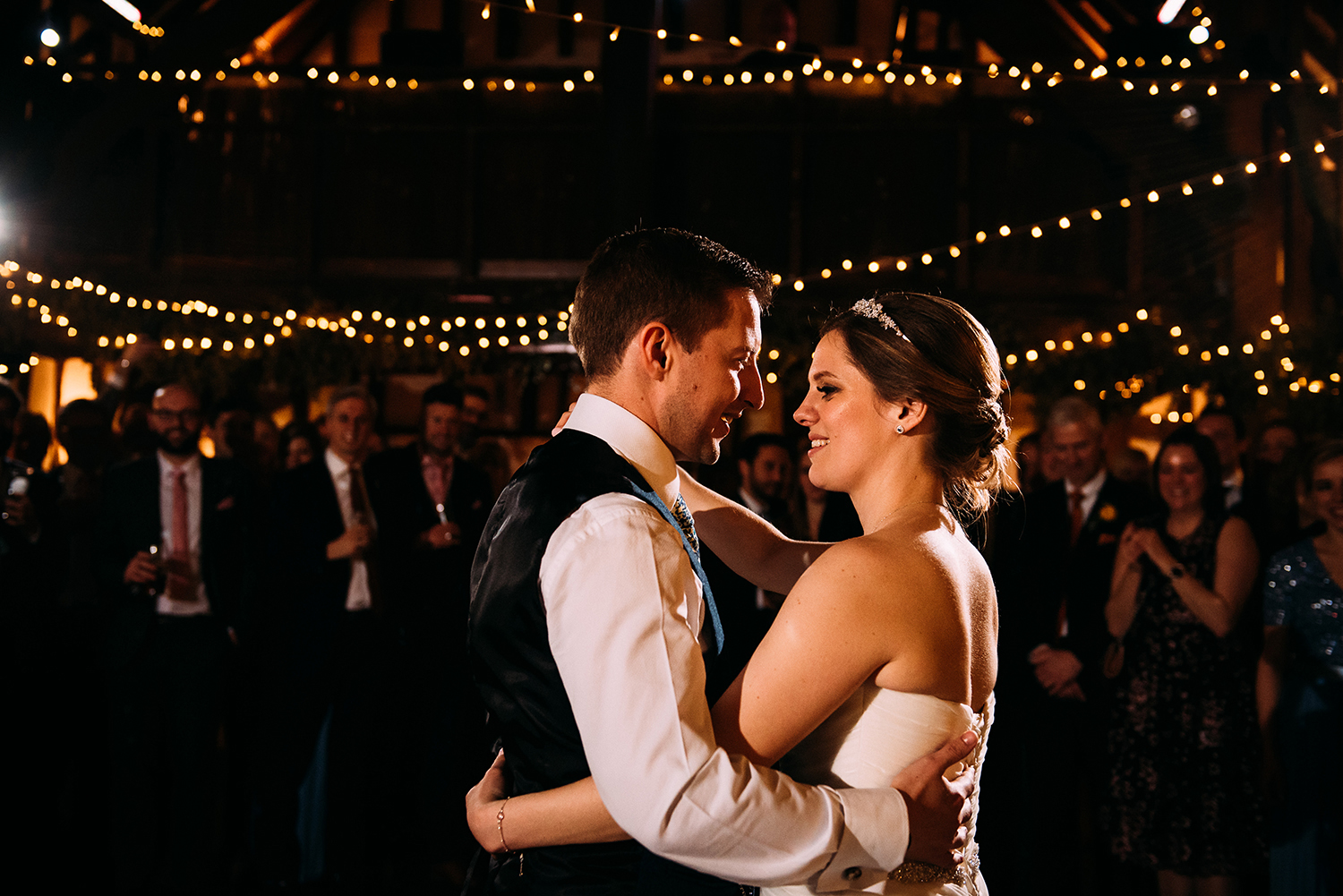 bride and groom first dance in the barn