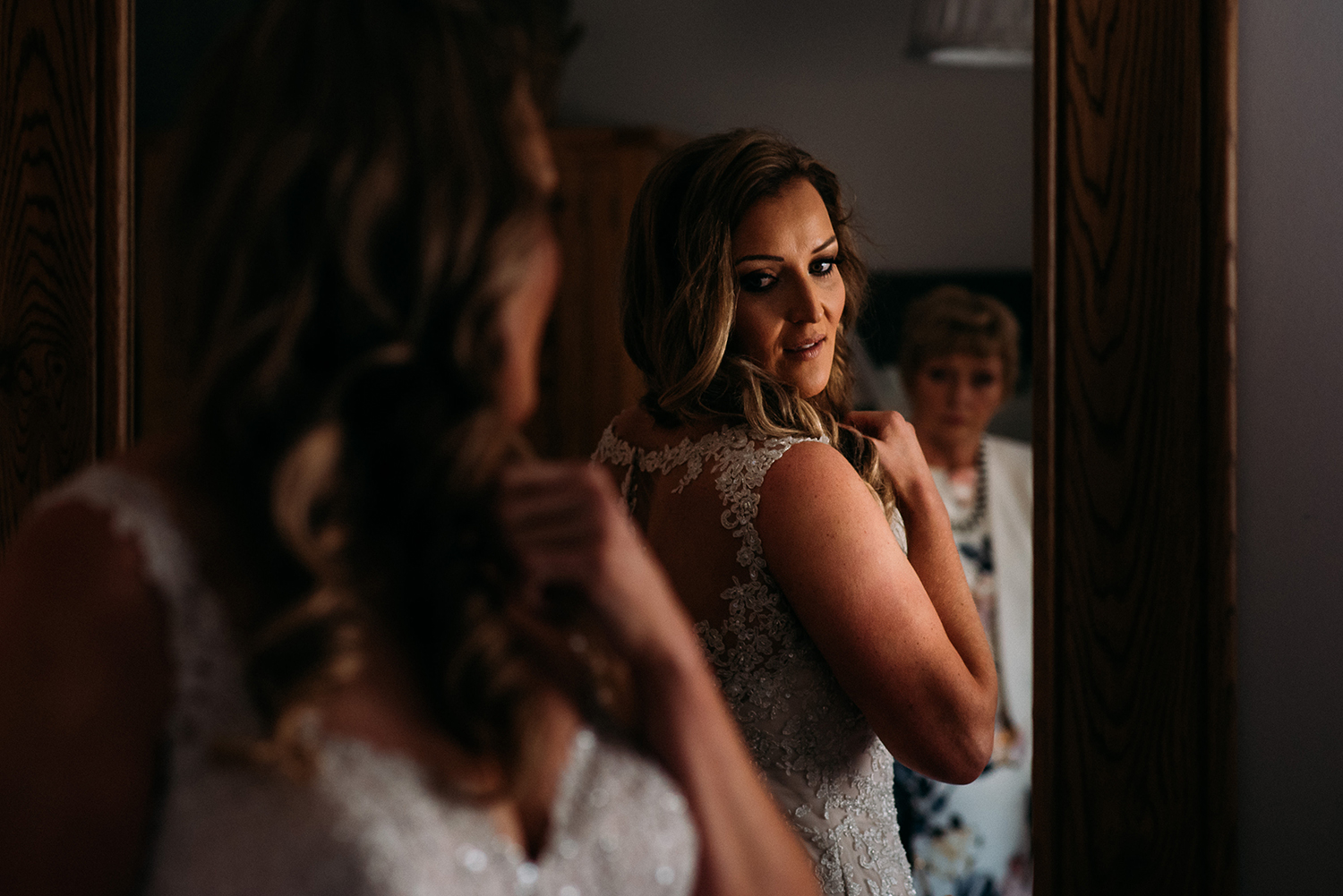 bride checks reflection in mirror