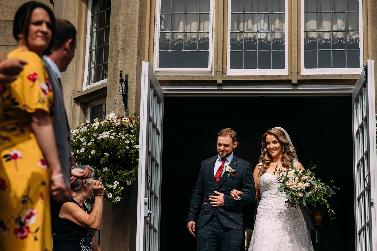 bride and groom walking out to confetti
