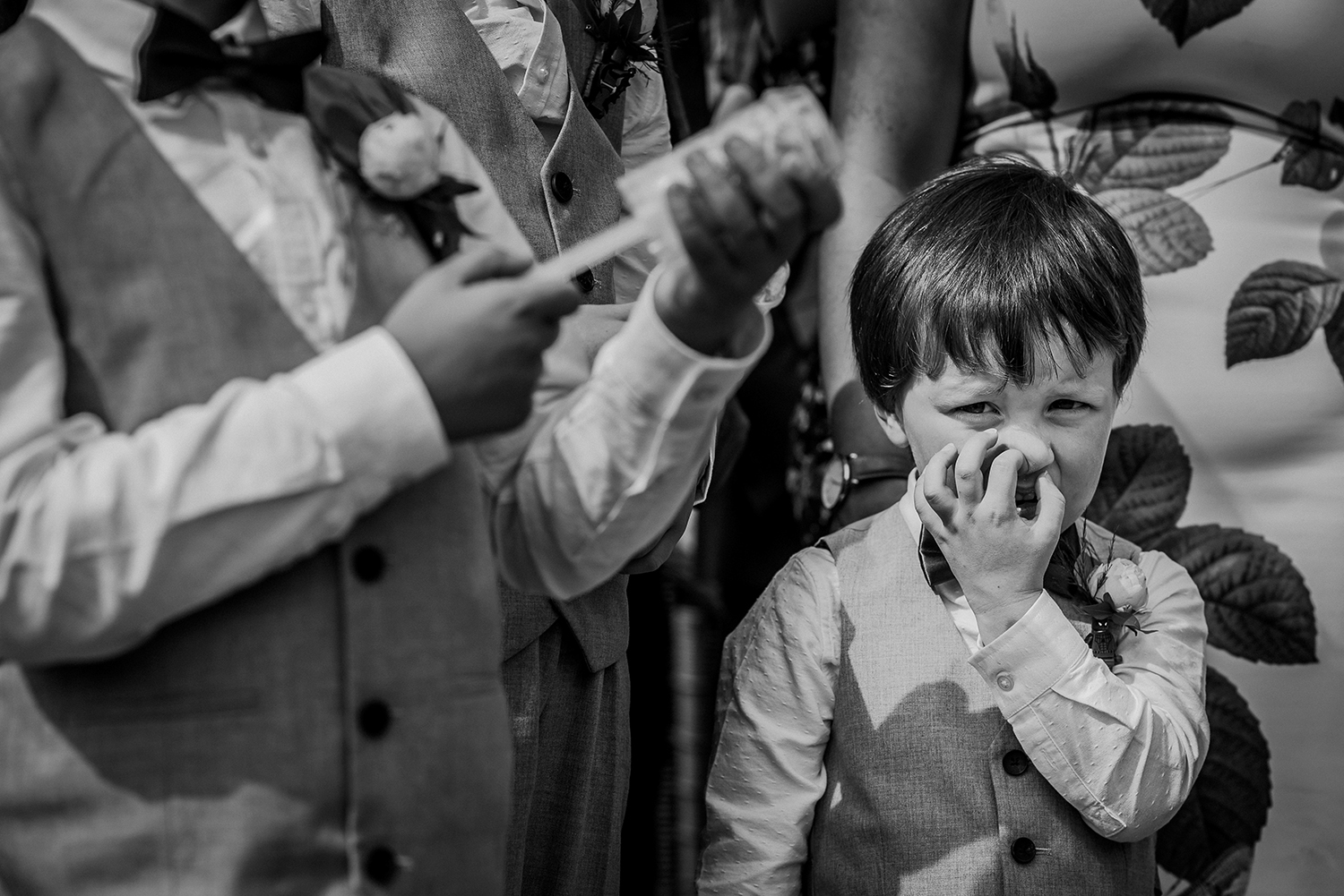 bw photo of boy picking his nose