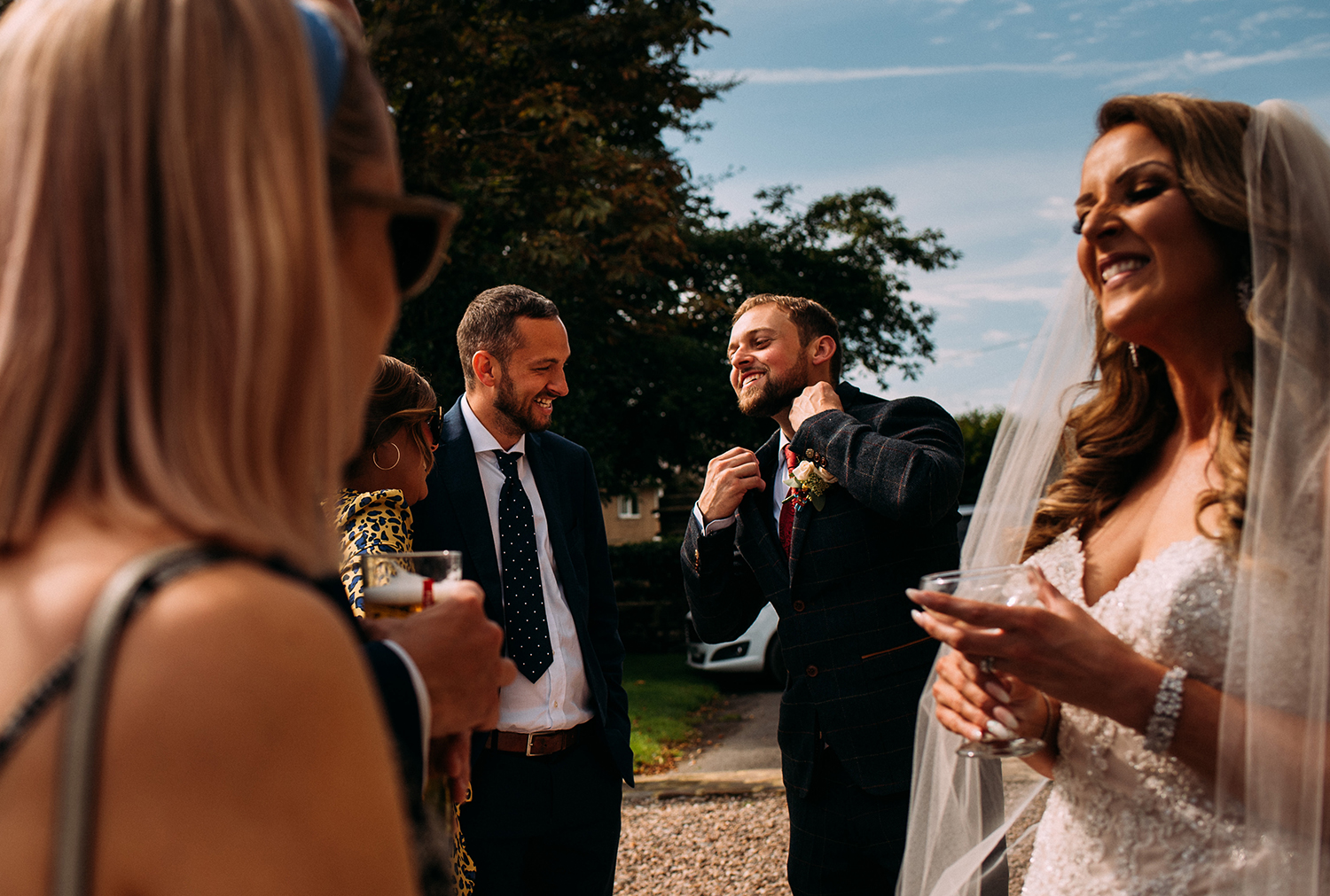 layered shot of bride and groom laughing with friends