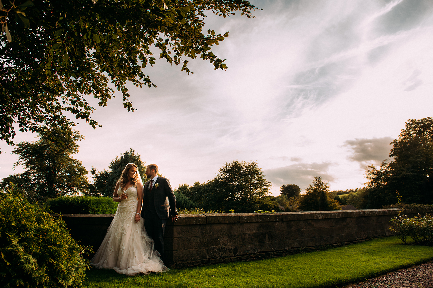 bride and groom relaxing on the wall