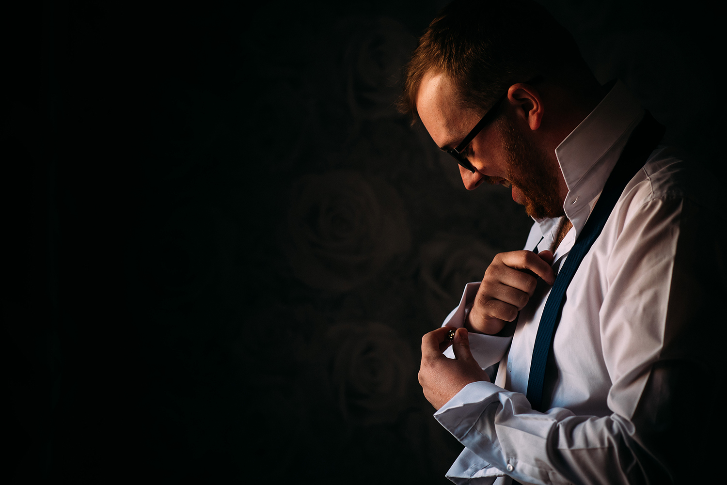 groom doing his cufflinks