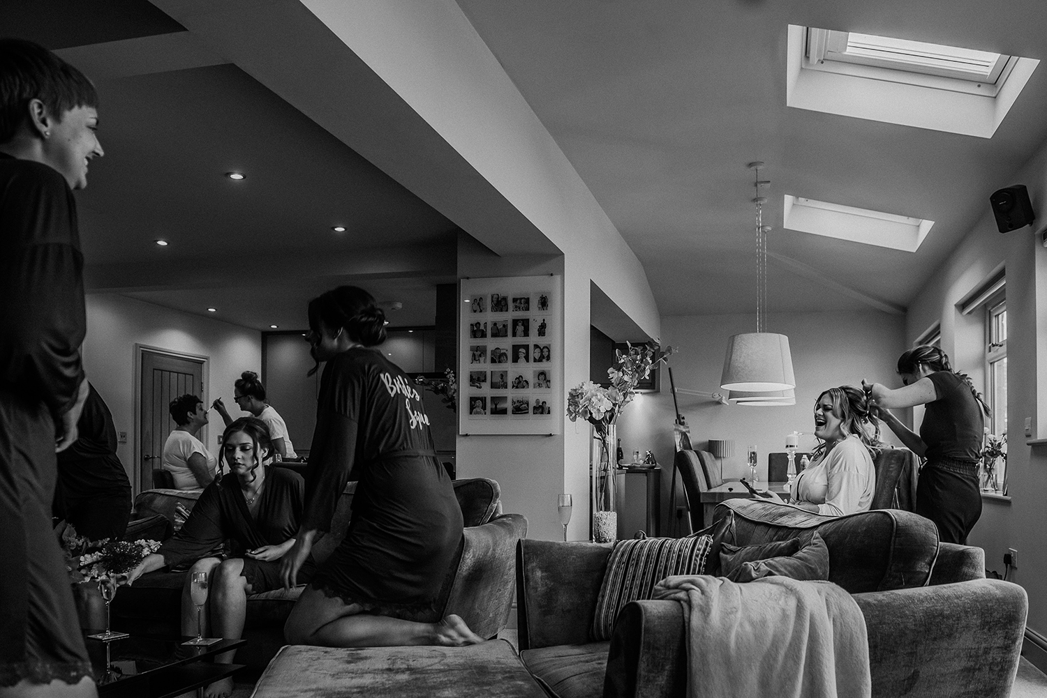 bw photo of the bride laughing with friends and family at home in the morning