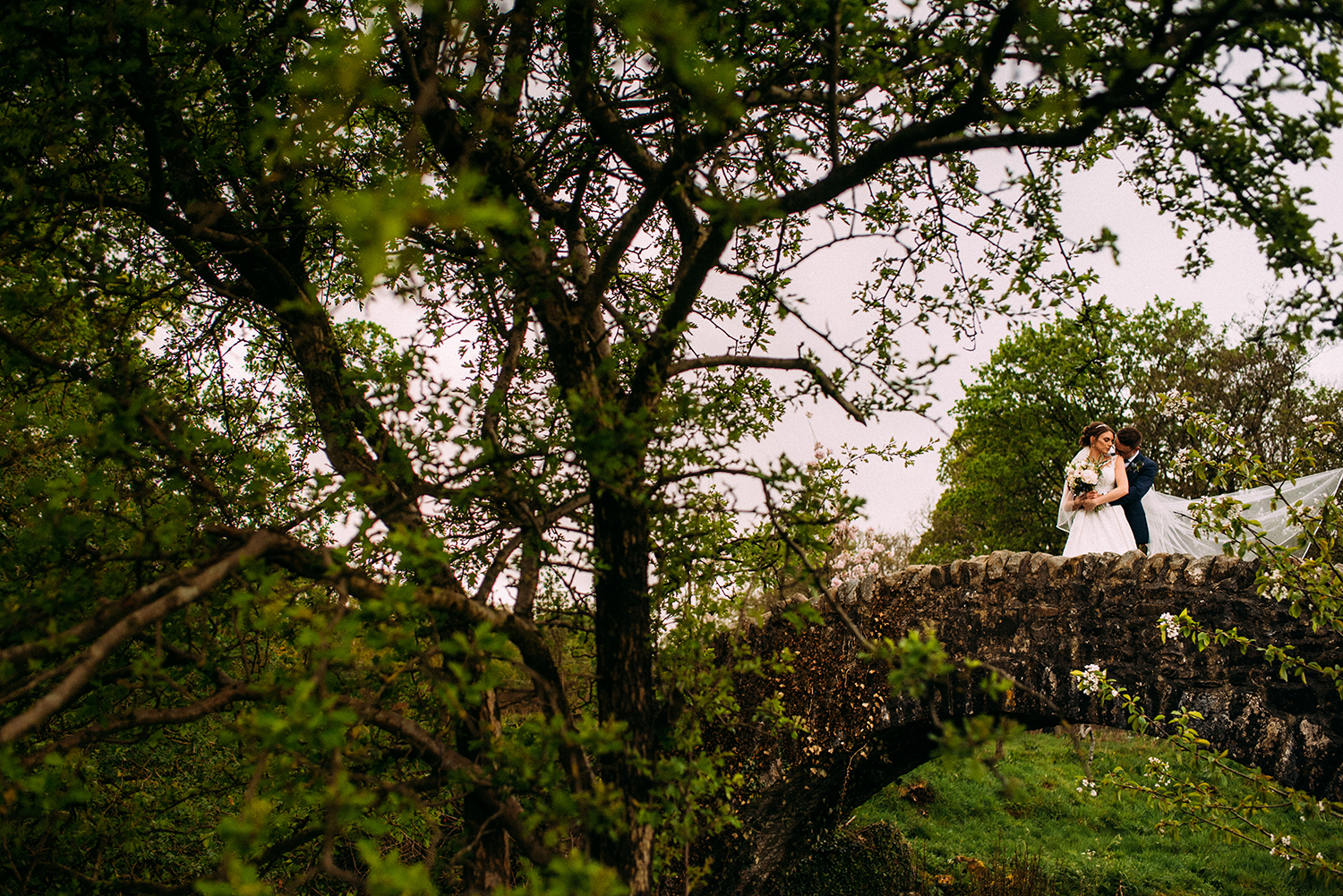 Bride and groom on the bridge together at the Out barn wedding venue
