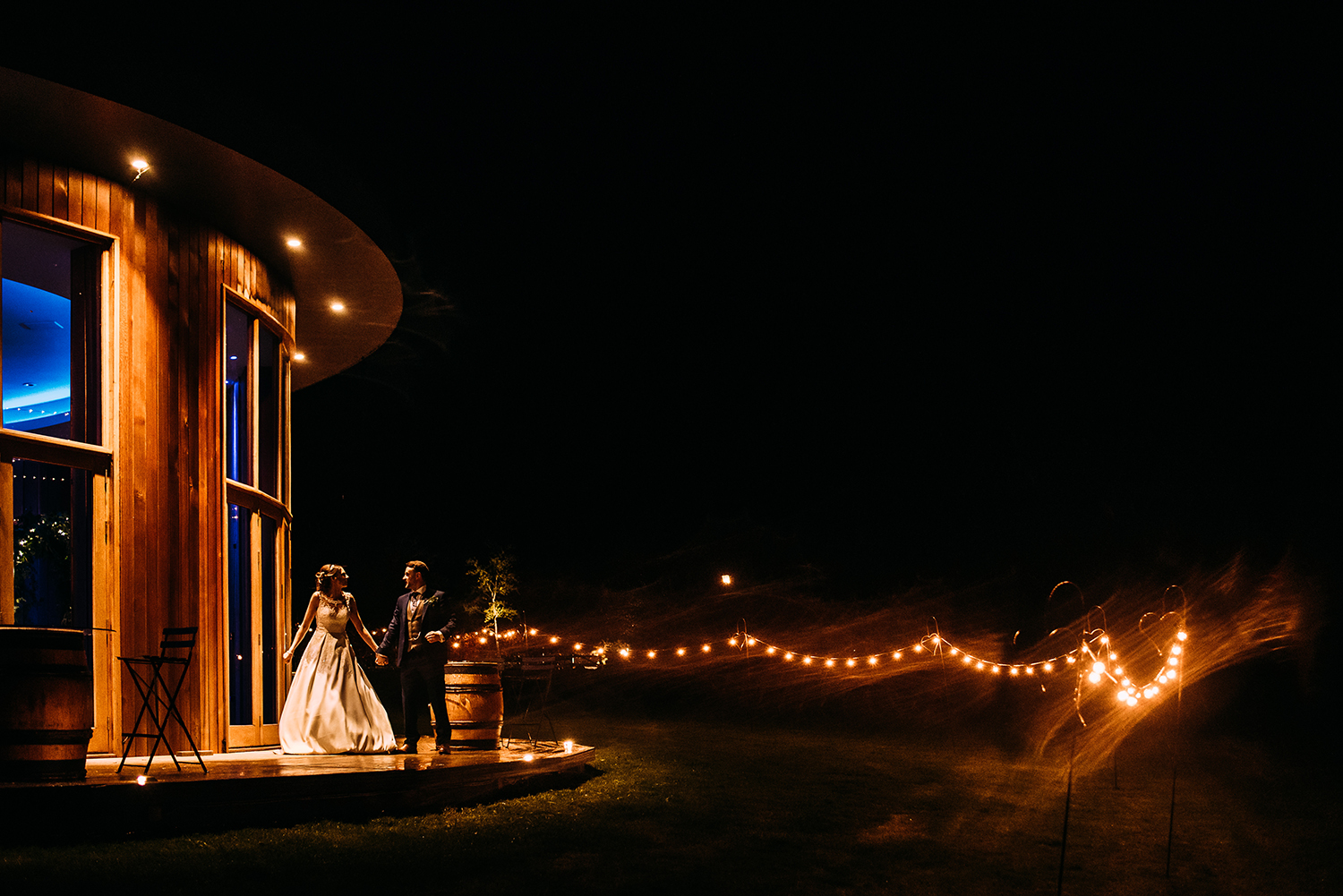 Bride and groom outside the Out barn wedding venue at night