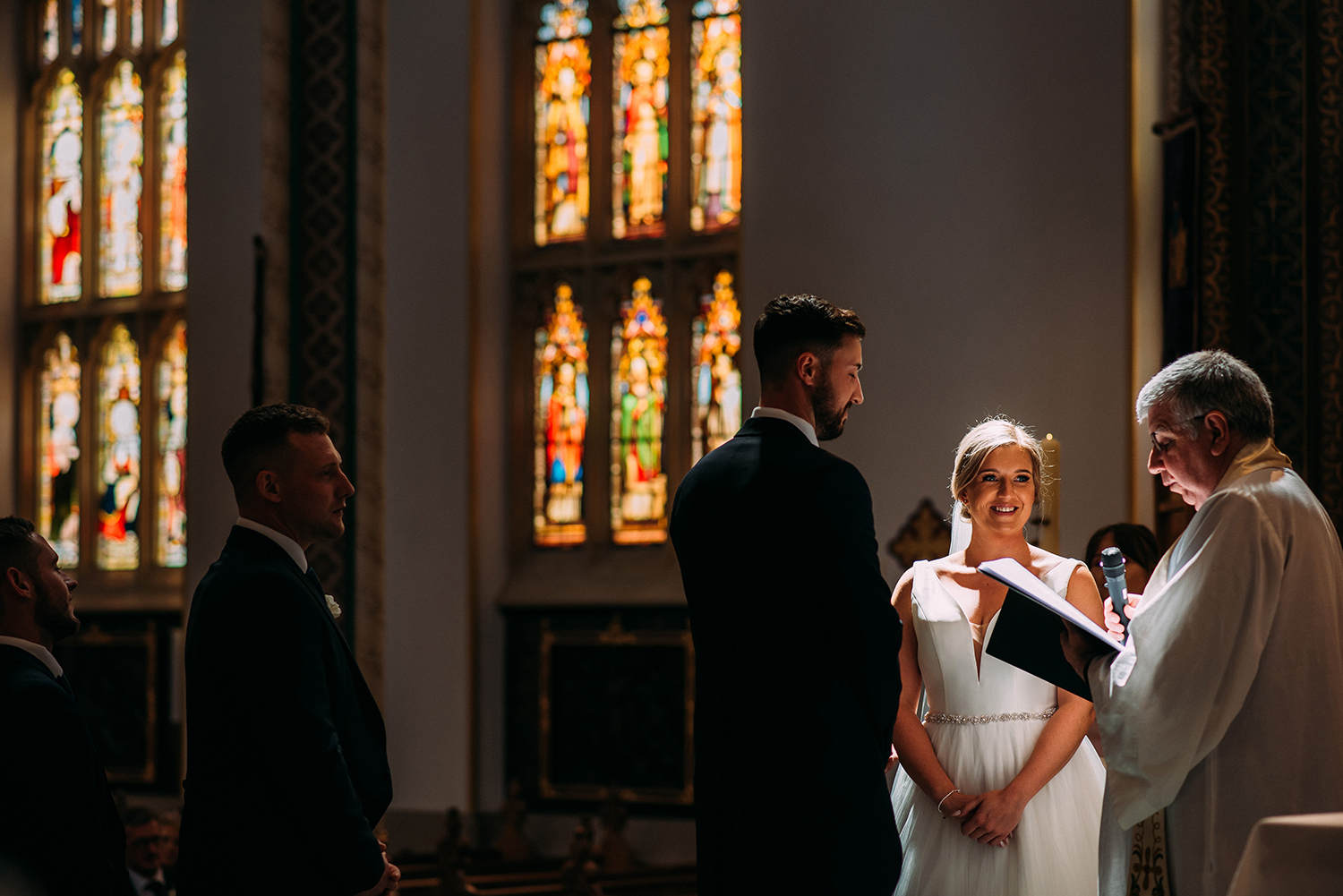 bride and groom in nice light at the alter