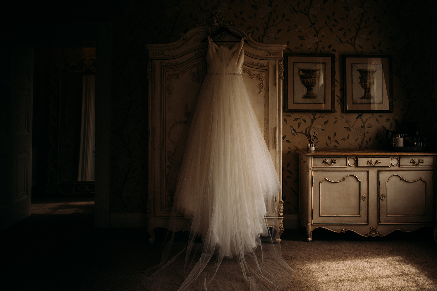 the wedding dress hanging up on the wardrobe