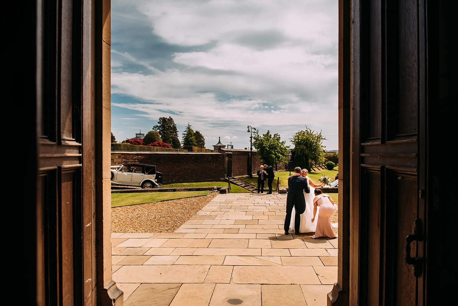 bride hugging guest as arriving at church