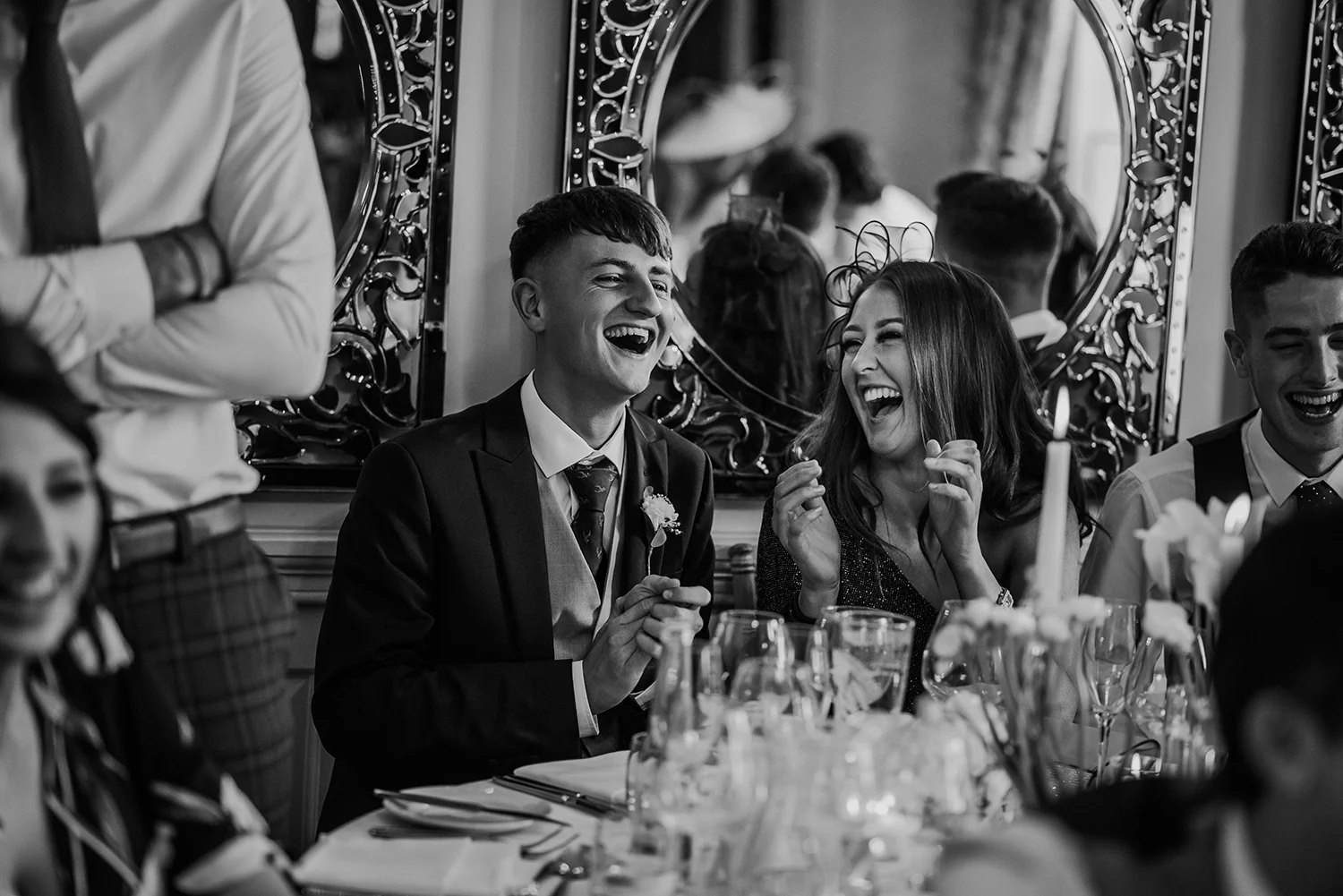 bw photo of the guests laughing at Eaves Hall