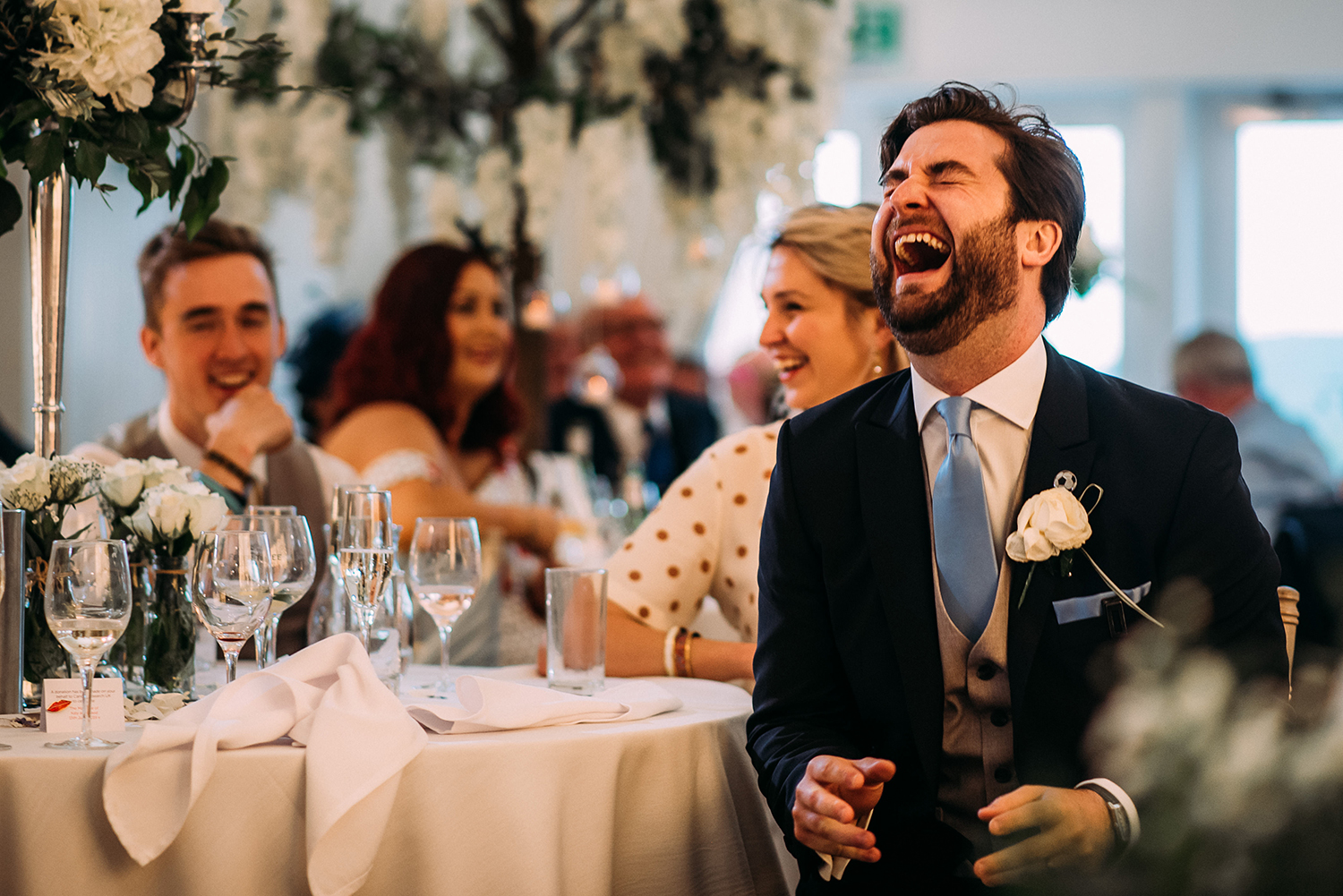 guest laughing during the speeches
