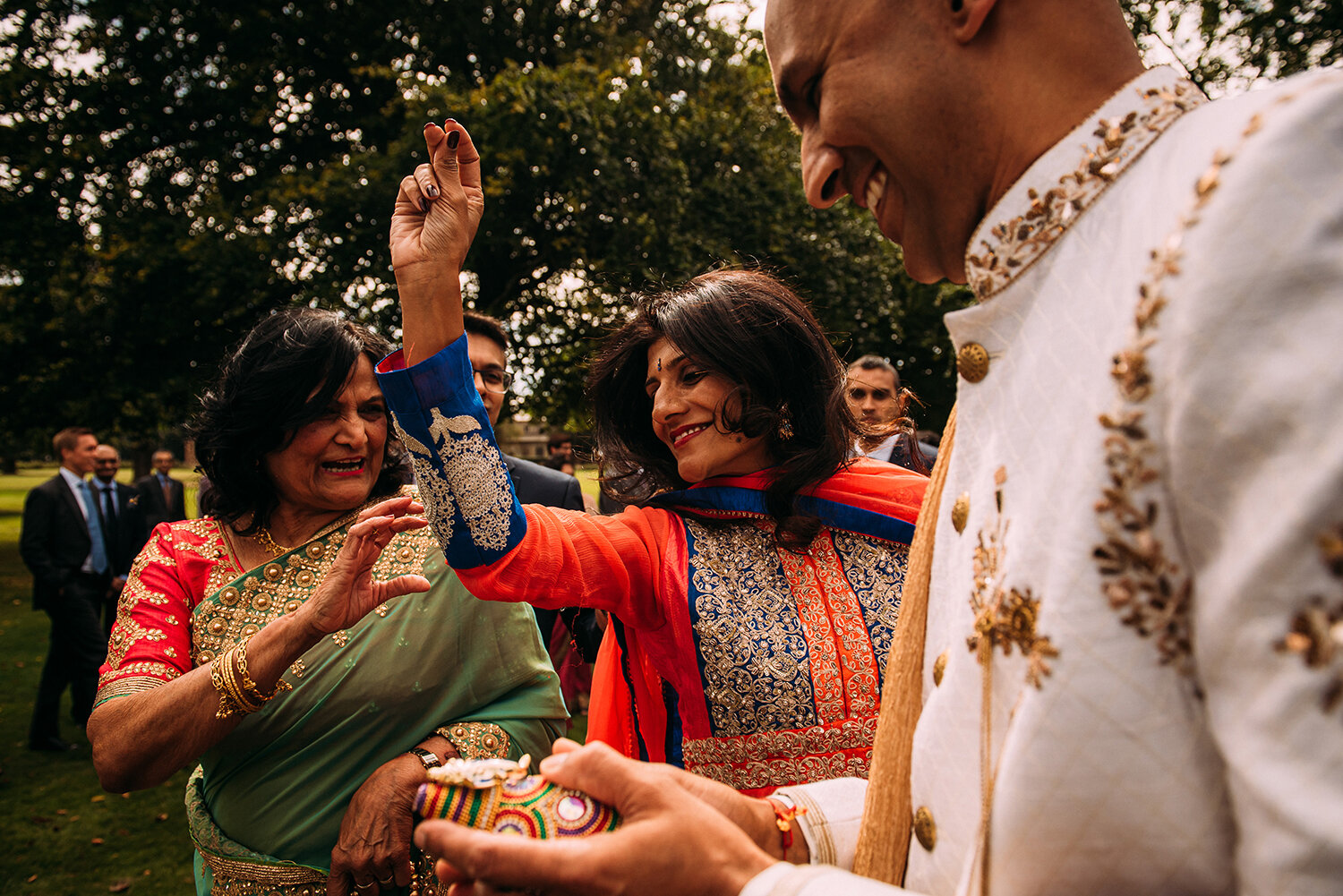  Groom and guests dancing between drums on the way to the Indian wedding ceremony 