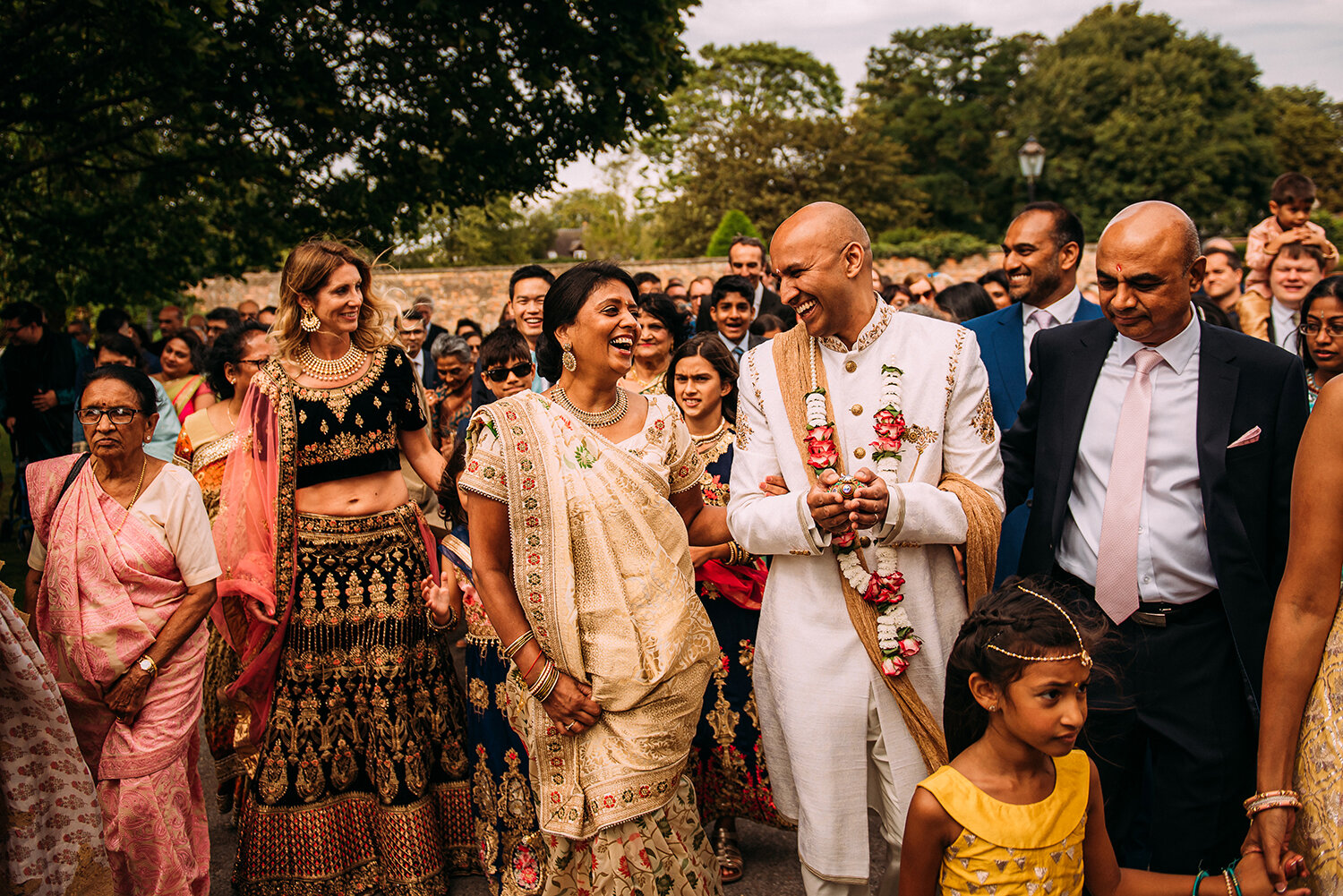  groom and brides mother laughing during the grooms procession 