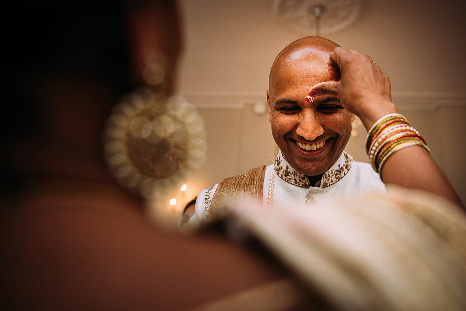  brides mother puts rice on grooms forehead 