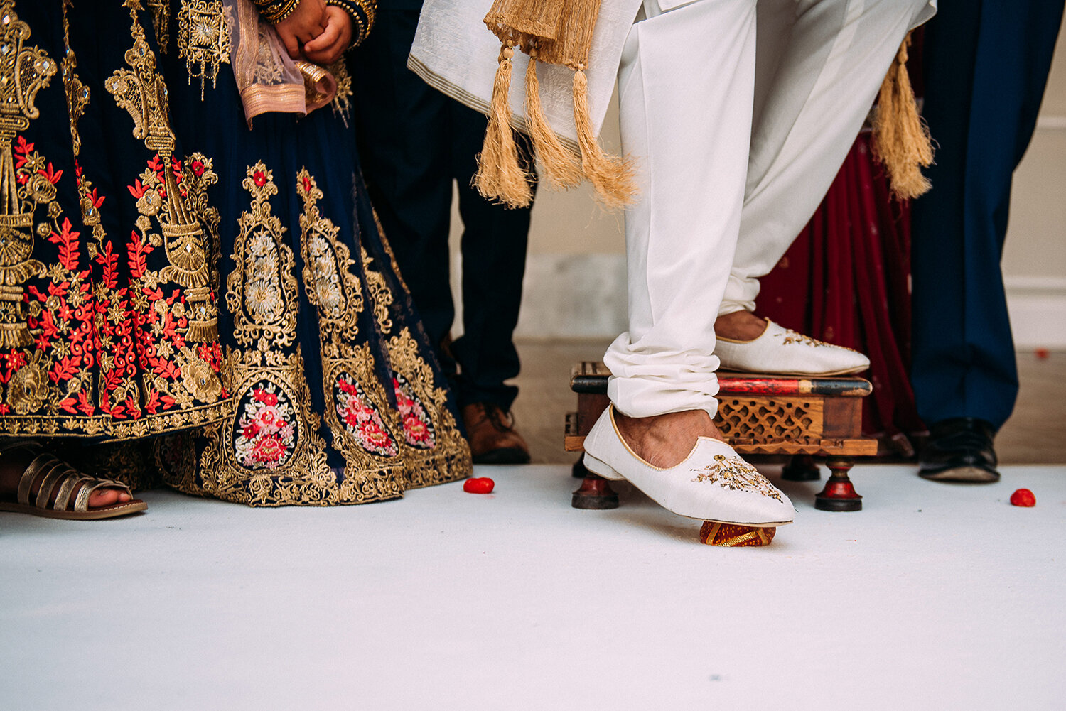  groom stands on cheese during wedding traditions 