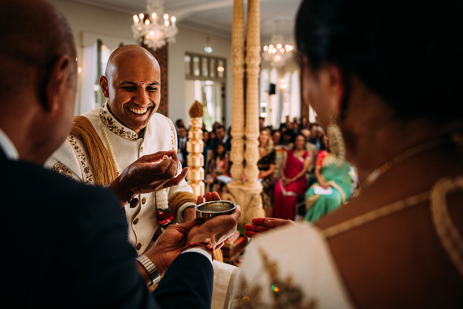  groom and brides parents on the mandap laughing 