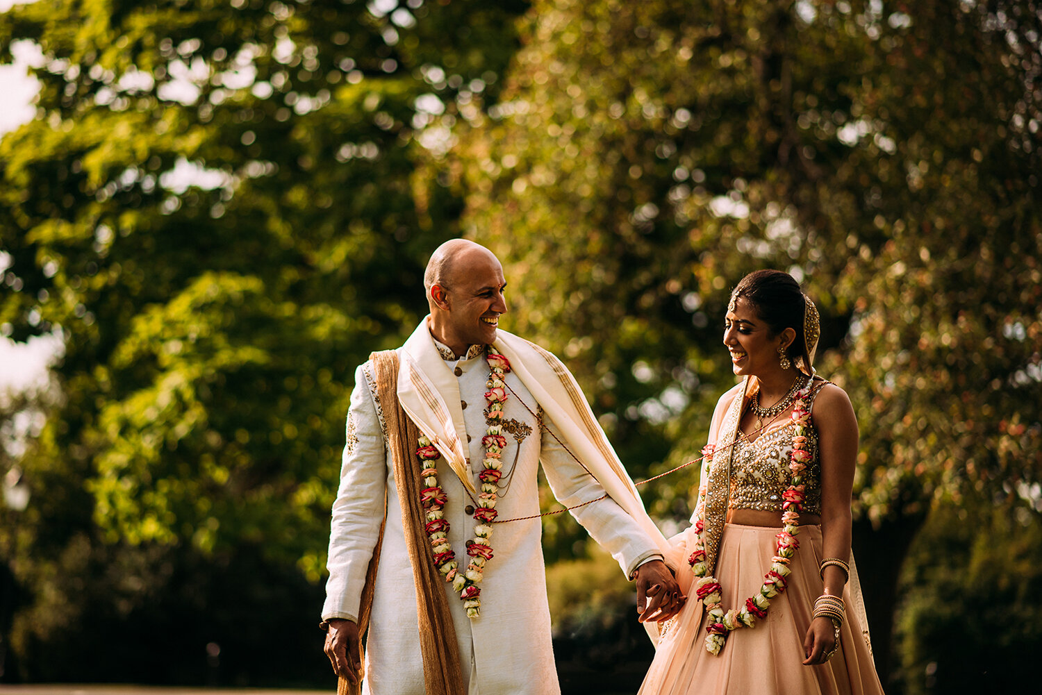  happy photo of the bride and groom walking and holding hands 