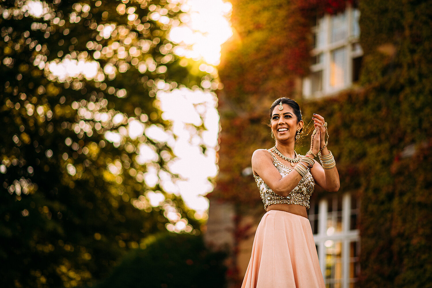  nice natural shot of the bride clapping while watching the groom play cricket as the low sun creeps around the building 