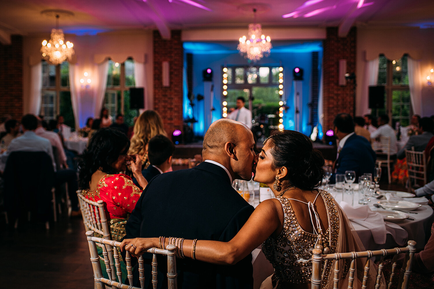  bride and groom kiss at the top table 