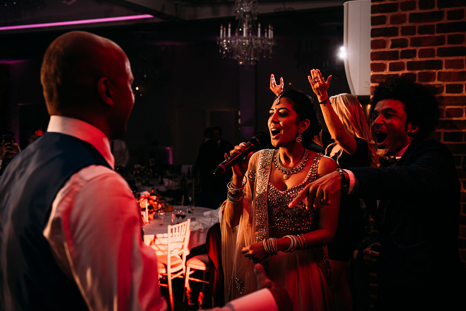  bride singing to the groom on stage 