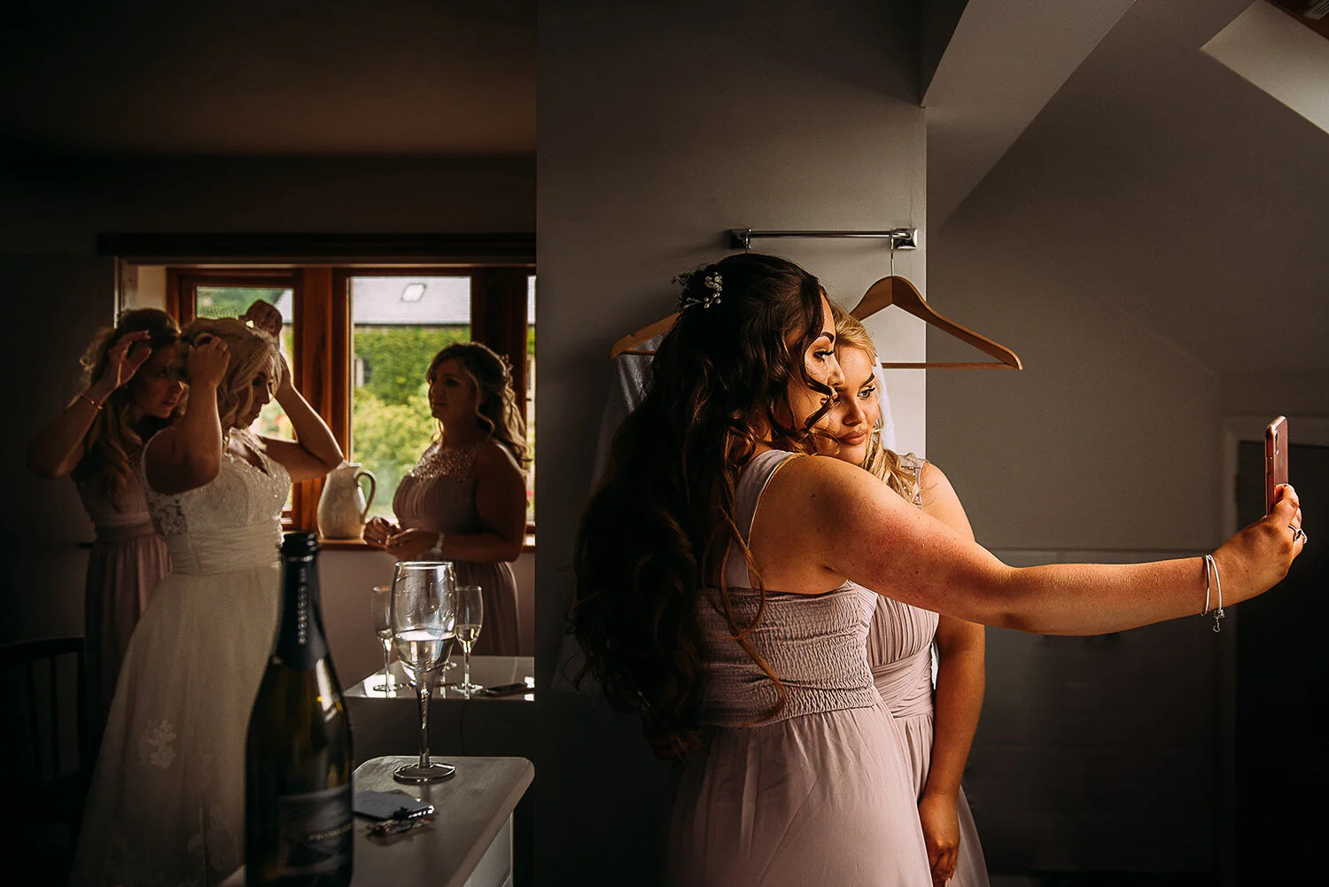 bride and bridesmaids getting ready at the out barn