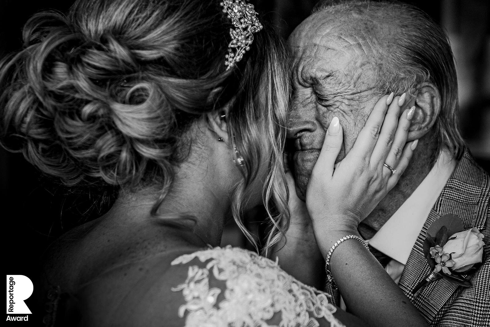  bride and father embracing before the wedding. Father holding back tears 