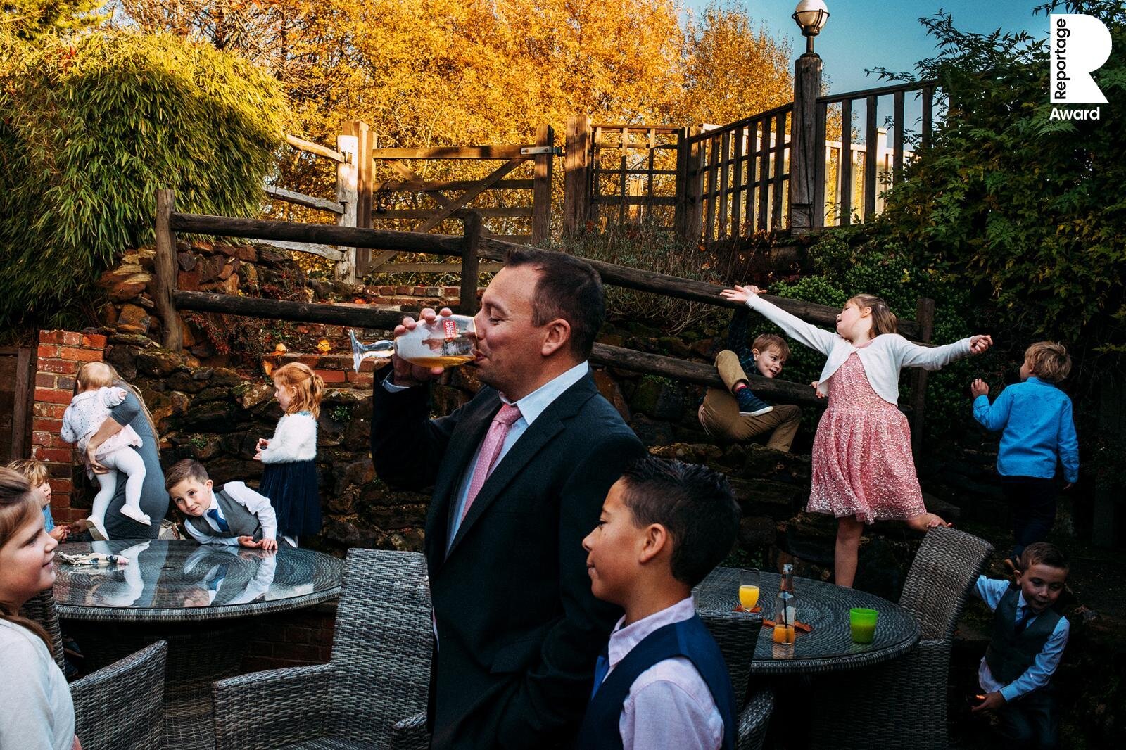  busy layered shot of kids playing and a man drinking beer 