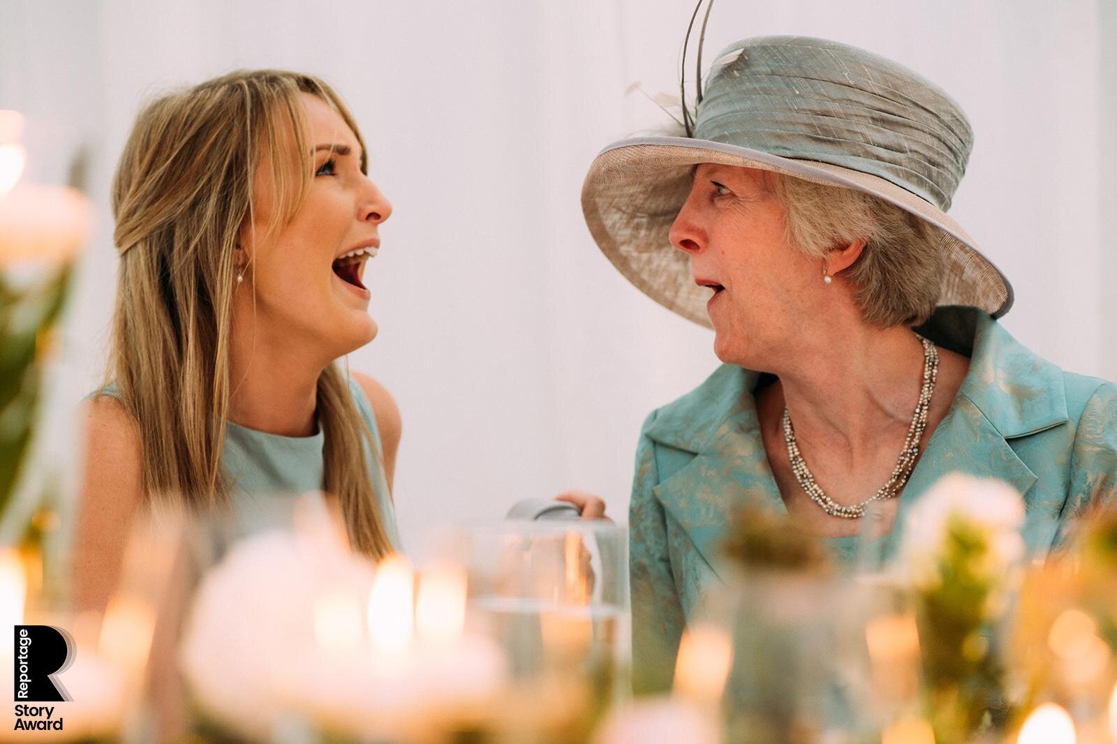  Grooms mother and bridesmaid laughing at the speeches 