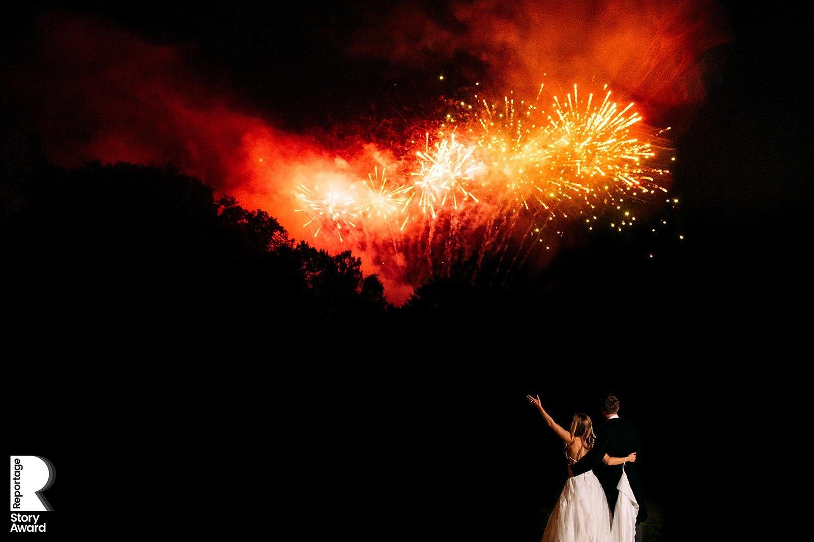  Bride and groom watching fireworks going off at Gisburn Parke Estate 