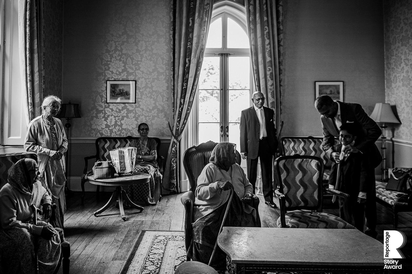  boy and elderly relatives in a quiet room at the wedding 