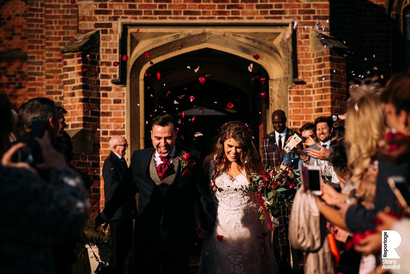  Bride and groom leave church through confetti in strong light 